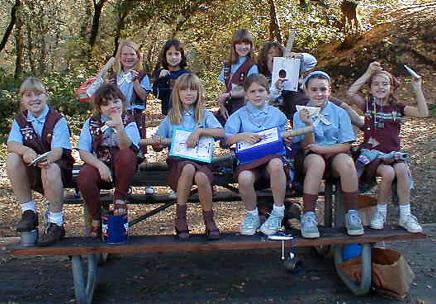 Girls show off the instruments they made at the park.
